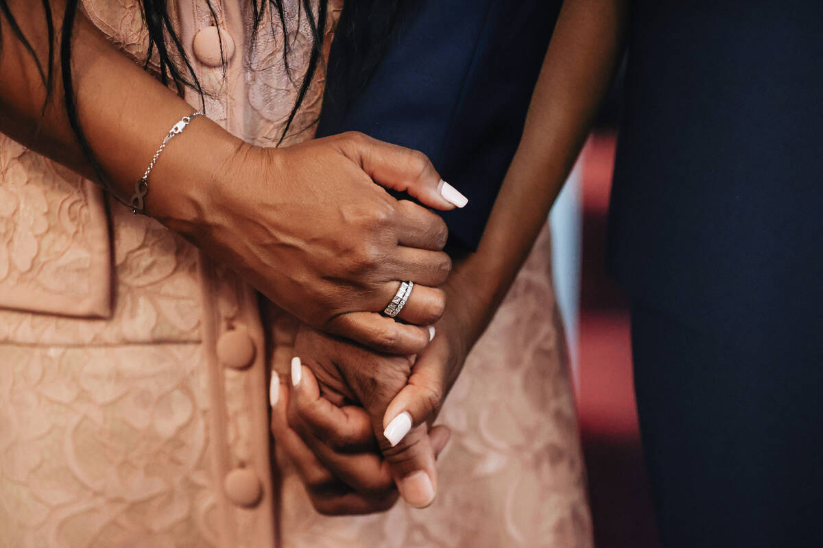 Berna Rhodes-Ford, left, holds the hand of her husband, Nevada Attorney General Aaron Ford, as ...