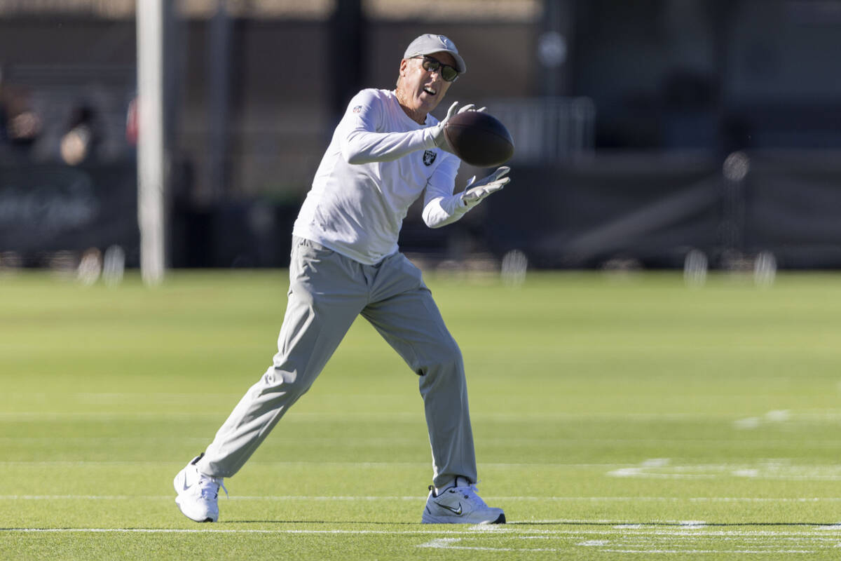 Raiders head coach Pete Carroll catches a football during the team’s training camp at th ...