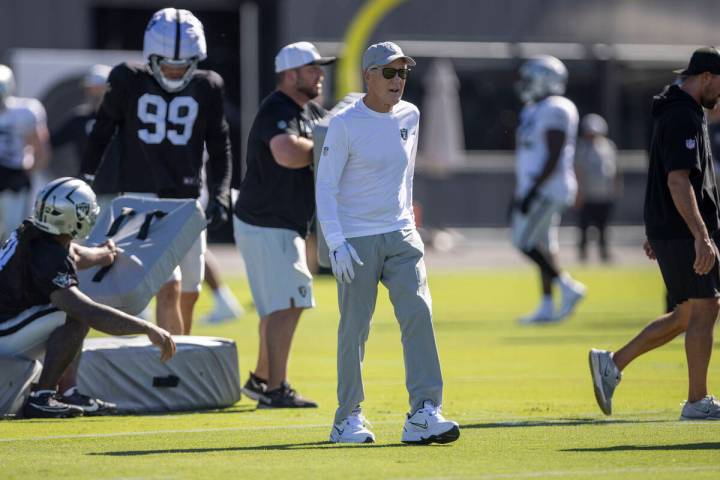 Raiders head coach Pete Carroll walks through practice during the team’s training camp a ...
