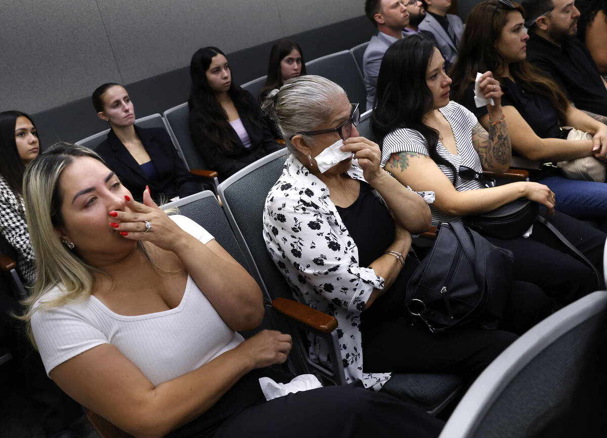 Family members of Angelina Erivas weep as they attend the trial of Isaac George, who is accused ...