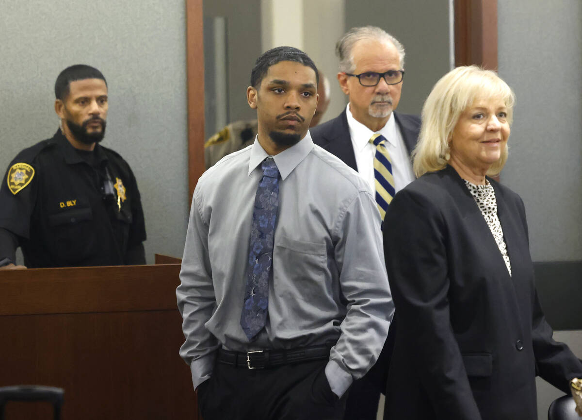 Isaac George is led into a courtroom with his attorneys Ozzie Fumo and Lisa Rasmussen during hi ...