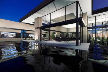 This artist's rendering shows a Blue Heron home under construction in MacDonald Highlands. Form ...