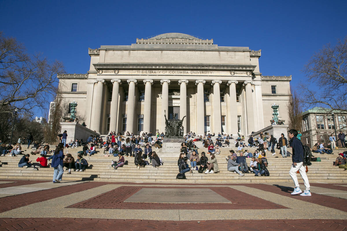 Students sit on the front steps of Low Memorial Library on the Columbia University campus in Ne ...