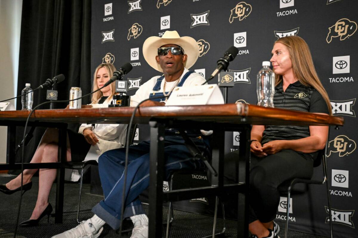 Colorado head coach DeIon Sanders, center, speaks beating bladder cancer during a news conferen ...