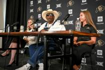 Colorado head coach DeIon Sanders, center, speaks beating bladder cancer during a news conferen ...