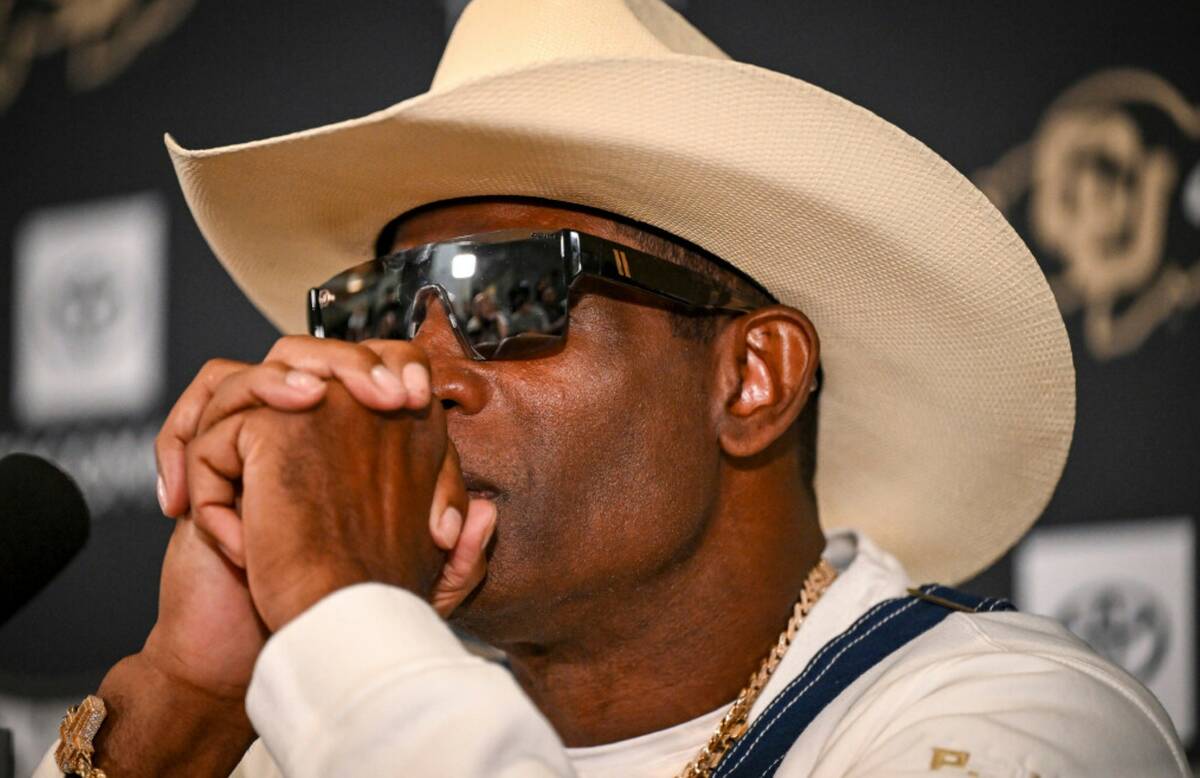 Colorado head coach Deion Sanders considers a question during a news conference to discuss his ...