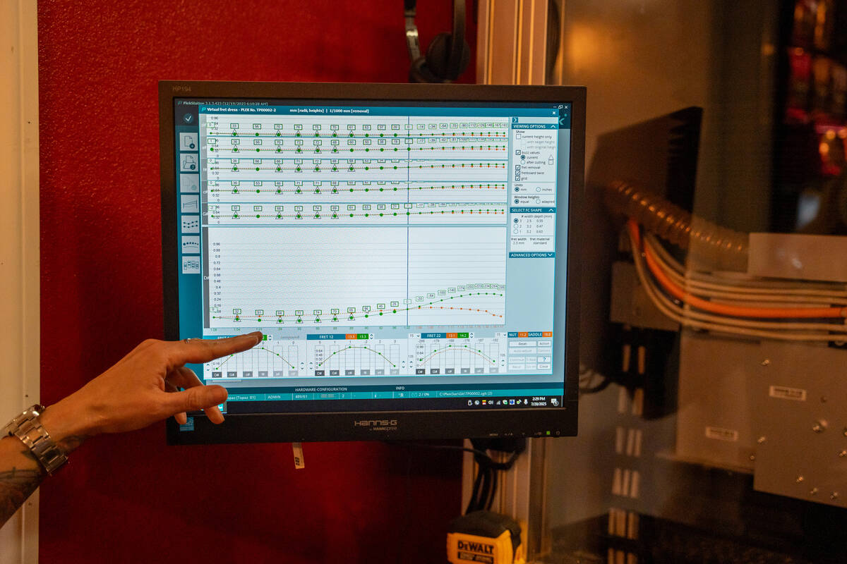 Teresa Topaz operates the Plek machine inside her at-home guitar repair shop in Las Vegas July ...