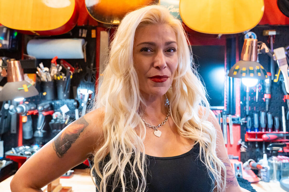 Teresa Topaz stands in her at-home guitar repair shop in Las Vegas, July 28, 2025. She is the o ...