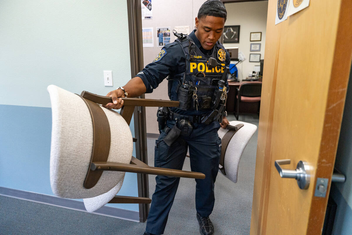 Tony Ladd carries chairs into the Clark County School District police department’s new wellne ...