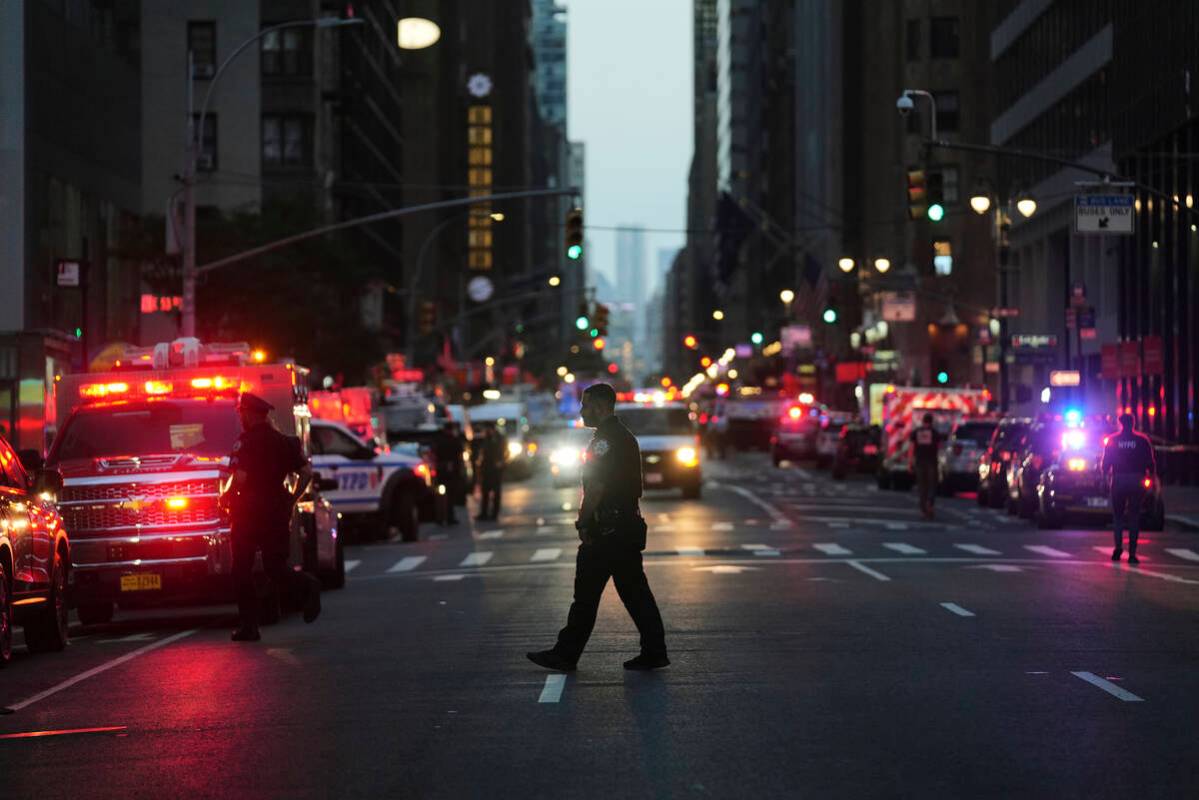 First responders gather on 52nd Street outside a Manhattan office building where two people wer ...