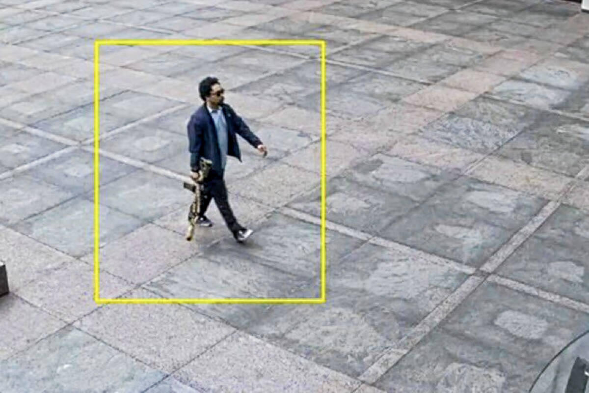 This image from surveillance video obtained by The Associated Press shows Shane Tamura outside ...