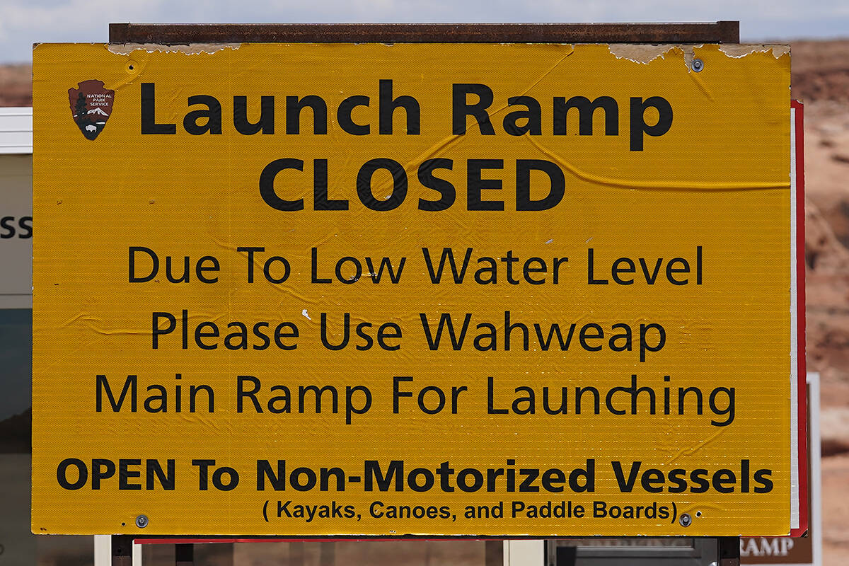 FILE - A "Launch Ramp Closed" sign is shown at the Antelope Point launch ramp on Lake Powell on ...
