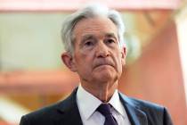 Federal Reserve Chairman Jerome Powell listens as President Donald Trump visits the Federal Res ...
