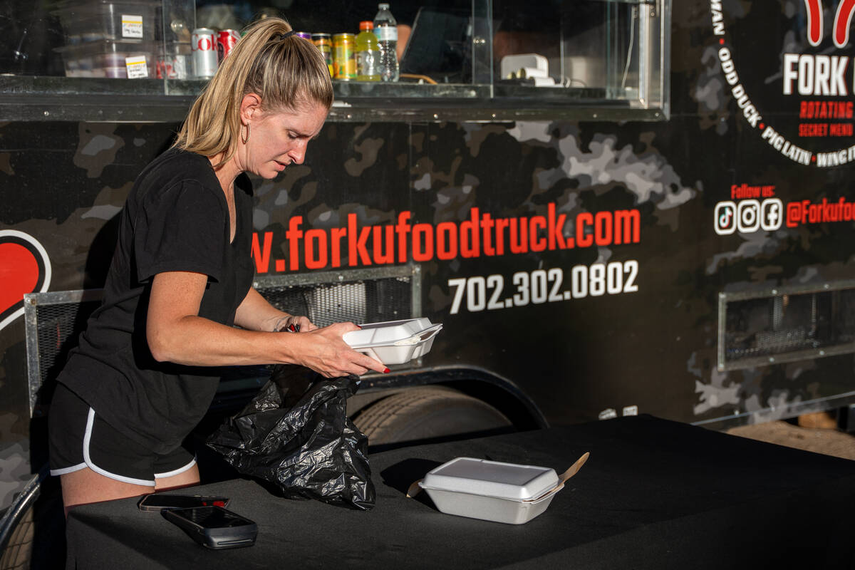 Sara Ignacio, co-owner of Fork U, bags a customer’s order after attending a public works ...