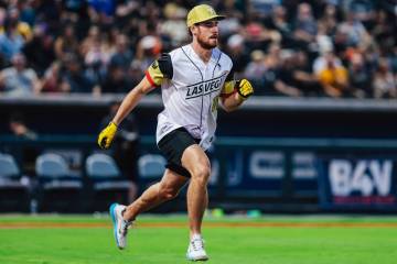 Golden Knights right wing Reilly Smith runs to first base during a Battle For Vegas charity sof ...
