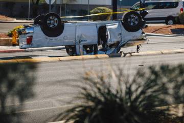 A truck lies overturned after a crash on Buffalo and Vegas Drive on Thursday, July 31, 2025, in ...