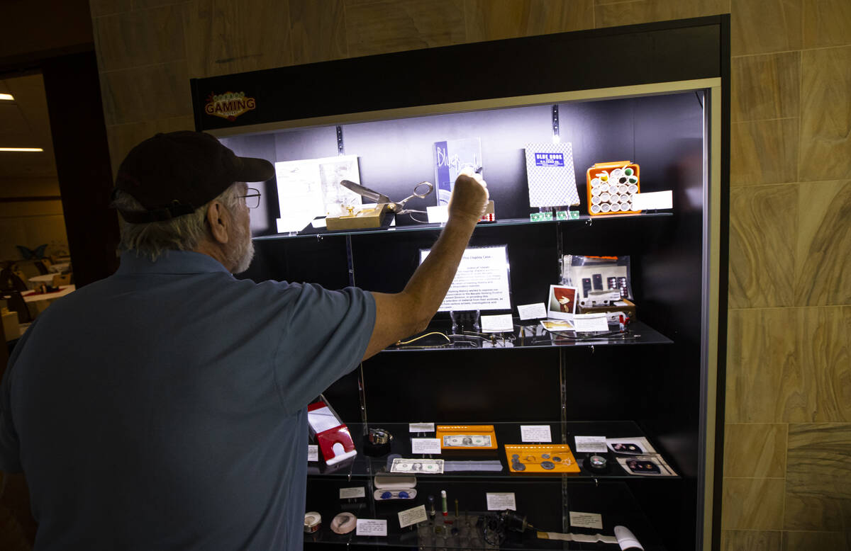 Jim Follis, vice-chair of the Museum of Gaming History, looks through a display case from the m ...