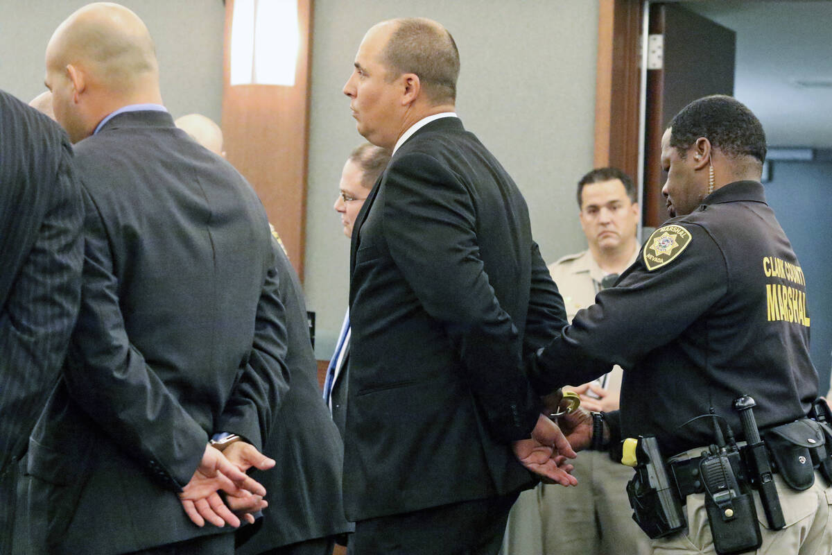 A marshal handcuffs Jeffrey Martin, who stands next to a handcuffed Mark Branco, left, in Judge ...