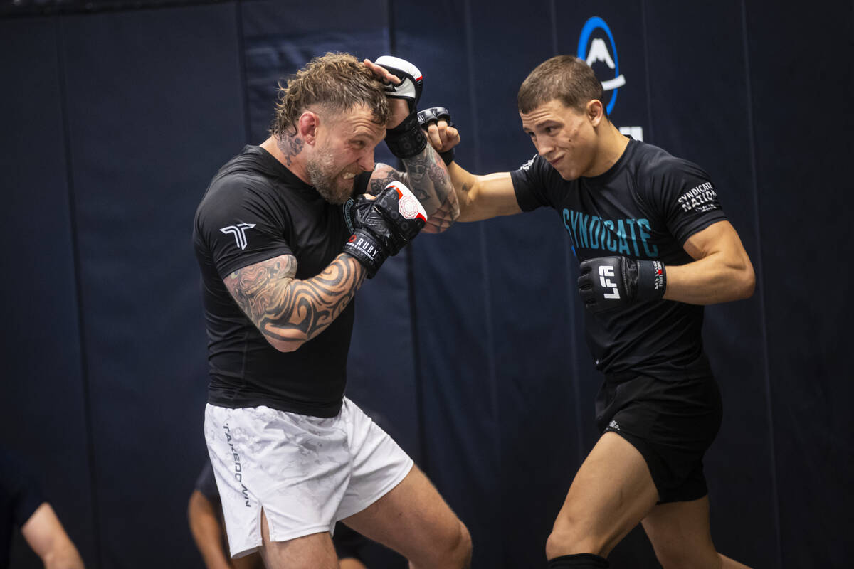 John Wood, owner and coach at Syndicate Mixed Martial Arts, left, demonstrates during a trainin ...