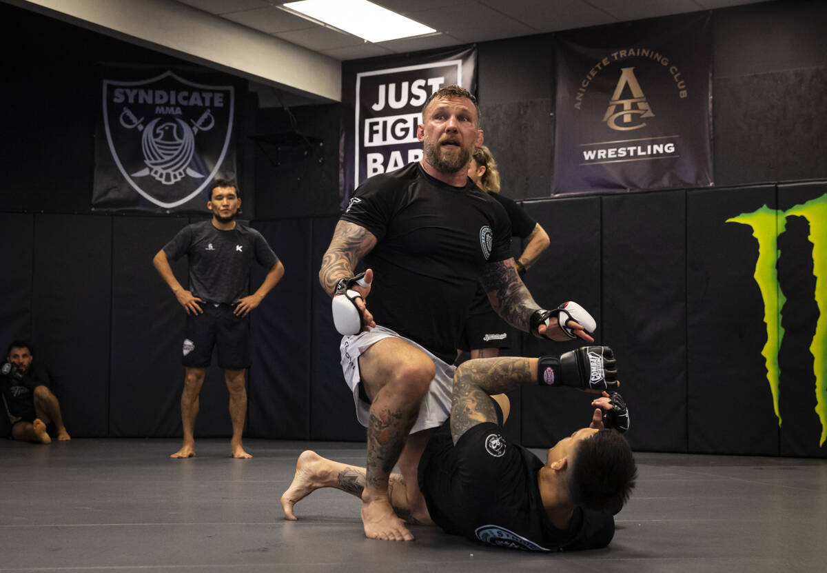 John Wood, owner and coach at Syndicate Mixed Martial Arts, left, demonstrates during a trainin ...