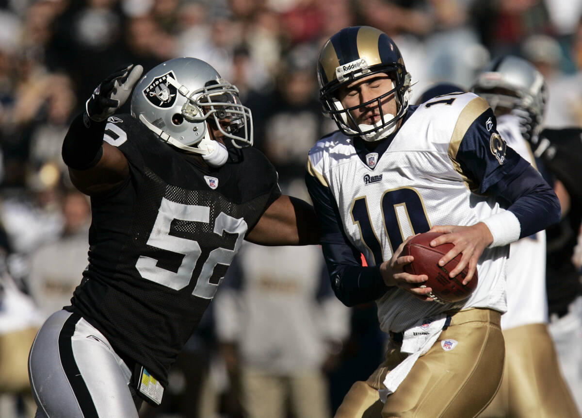 St. Louis Rams quarterback Marc Bulger (10) is sacked by Oakland Raiders linebacker Kirk Morris ...