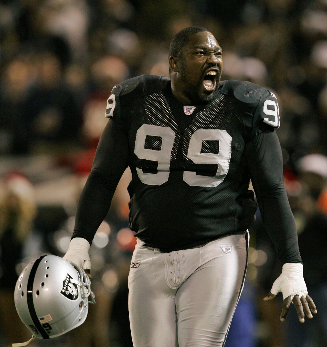Oakland Raiders' Warren Sapp yells toward the crowd during a break in action against the Kansas ...