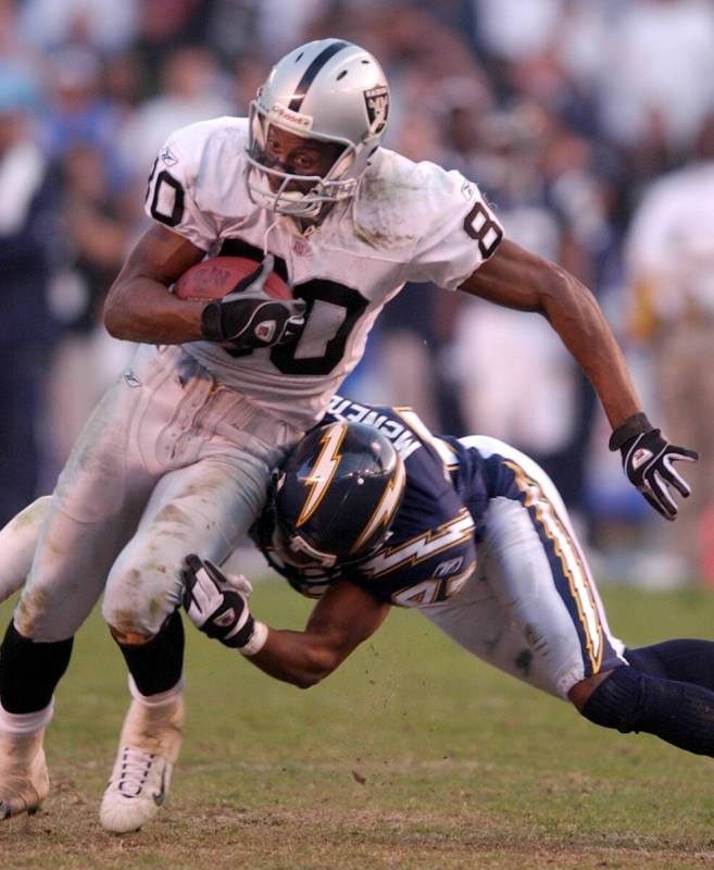 Oakland Raiders' Jerry Rice drags San Diego Chargers' Ryan McNeil after one of his seven catche ...