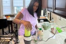 In this photo provided by Phyllis Jones, she prepares a smoothie with spinach, frozen blueberri ...