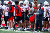 UNLV defensive coordinator Paul Guenther, right, yells from the sidelines during football sprin ...