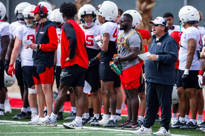 UNLV defensive coordinator Paul Guenther, right, yells from the sidelines during football sprin ...