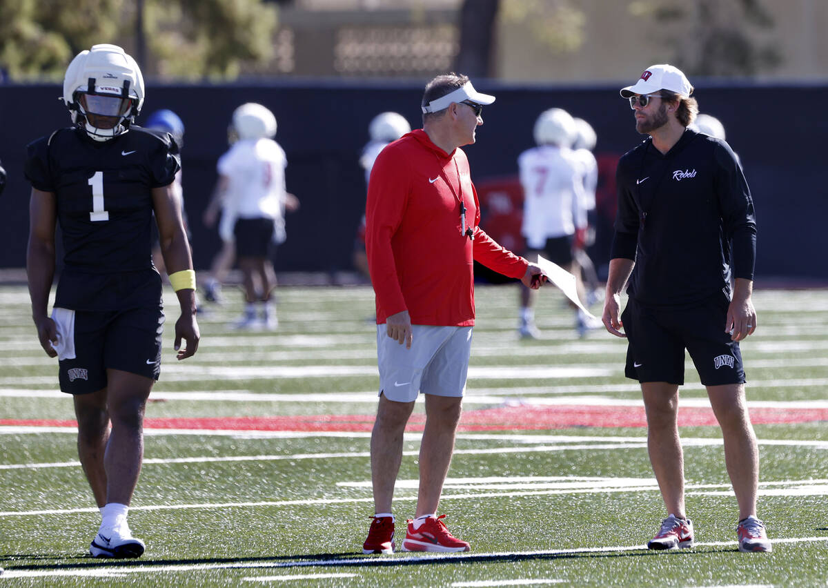 UNLV quarterback Alex Orji (1) walks past head coach Dan Mullen, center, and offensive coordina ...