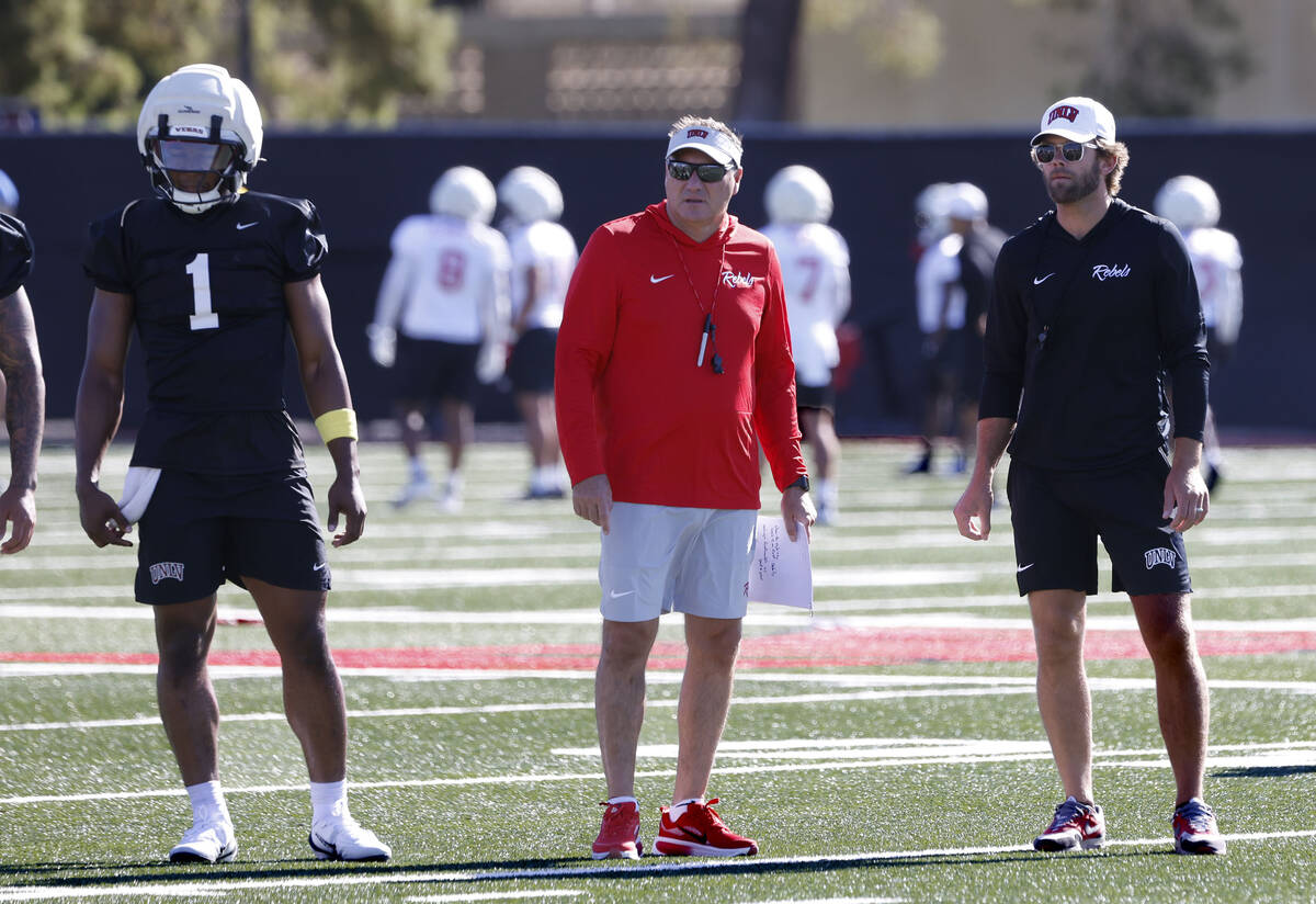 UNLV quarterback Alex Orji (1) head coach Dan Mullen, center, and offensive coordinator Corey D ...