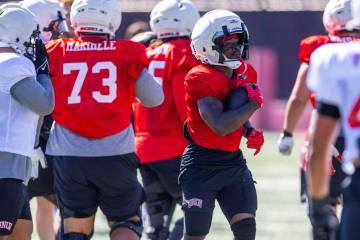 UNLV running back Jai'Den Thomas (9) takes a hand off past the line during football practice at ...