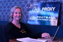 Toni Law, one of owners of Football Contest Proxy, works on her laptop as she waits to meet wit ...