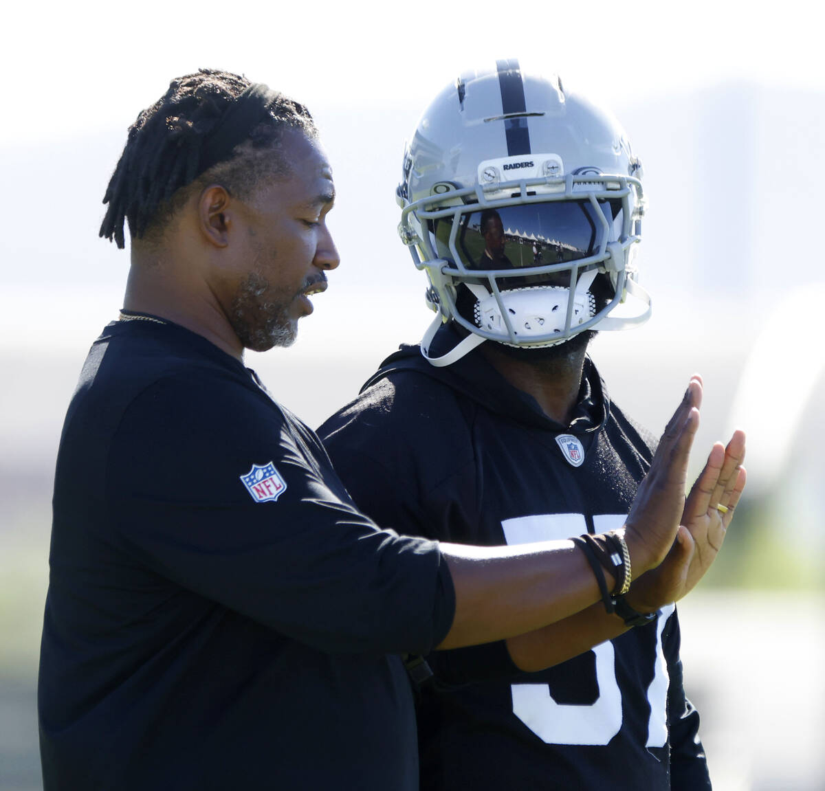 Raiders line backer Germaine Pratt (57) listens to defensive coordinator Patrick Graham during ...