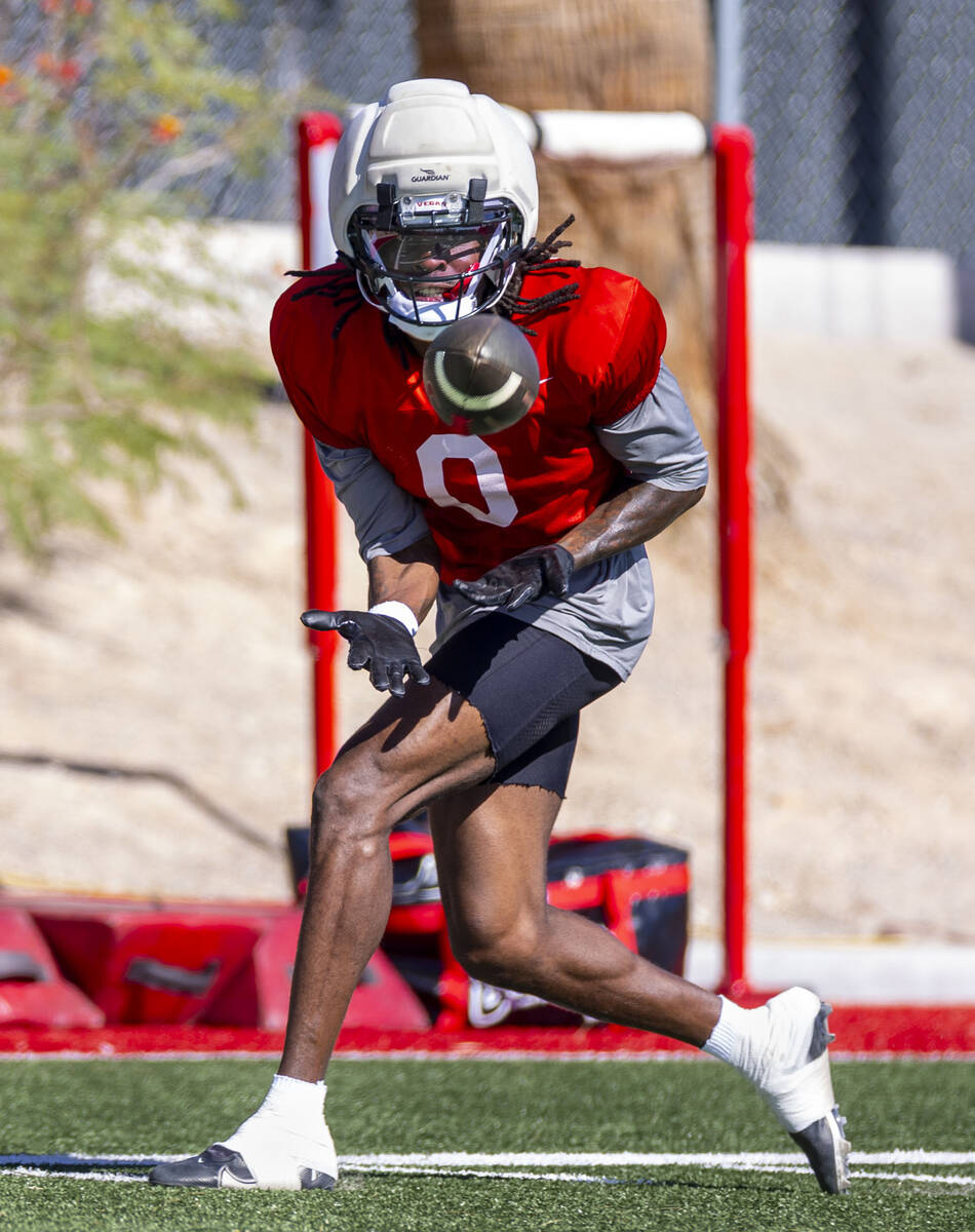 UNLV wide receiver Troy Omeire (0) looks in a pass during football practice at the Fertitta Foo ...