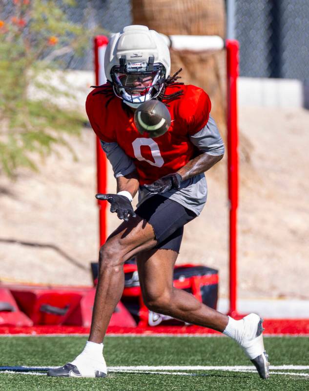 UNLV wide receiver Troy Omeire (0) looks in a pass during football practice at the Fertitta Foo ...