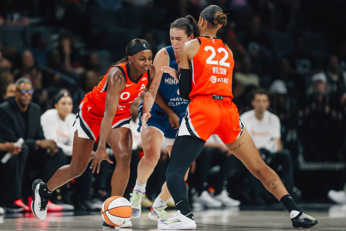 Aces guard Jackie Young (0) tries to round the ball during a WNBA basketball game between the A ...