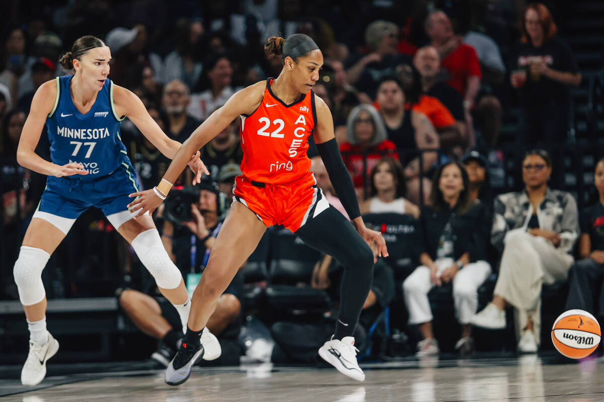 Aces center A'ja Wilson (22) and Minnesota Lynx forward Maria Kliundikova (77) eye the ball as ...