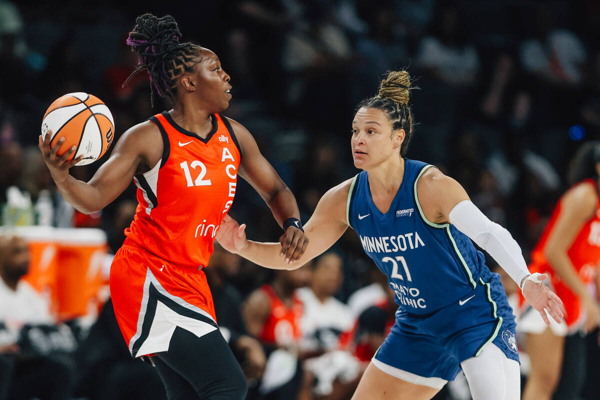 Aces guard Chelsea Gray (12) looks to pass the ball as Minnesota Lynx guard Kayla McBride (21) ...