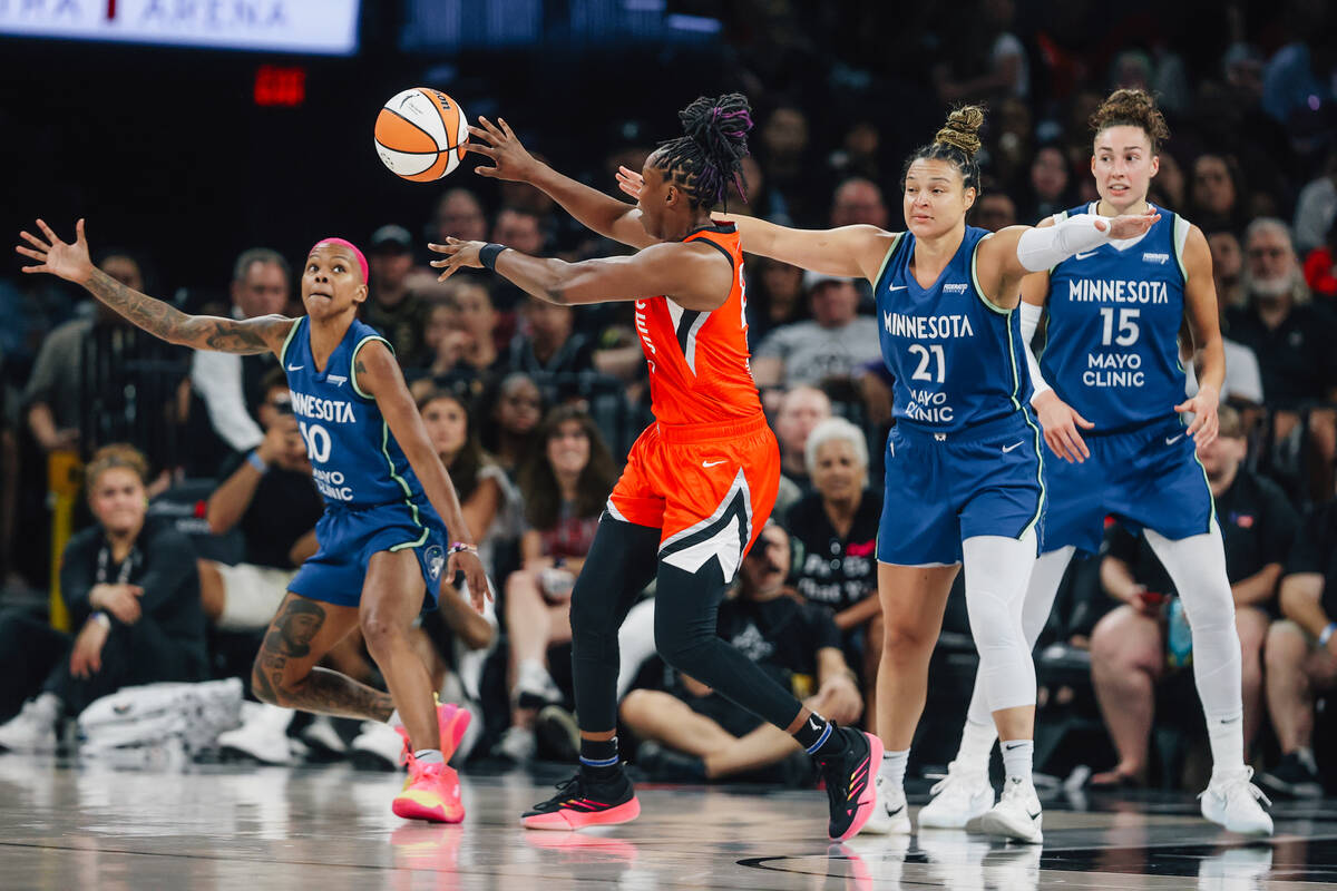 Aces guard Chelsea Gray (12) passes the ball as Minnesota Lynx guard Courtney Williams (10) tri ...