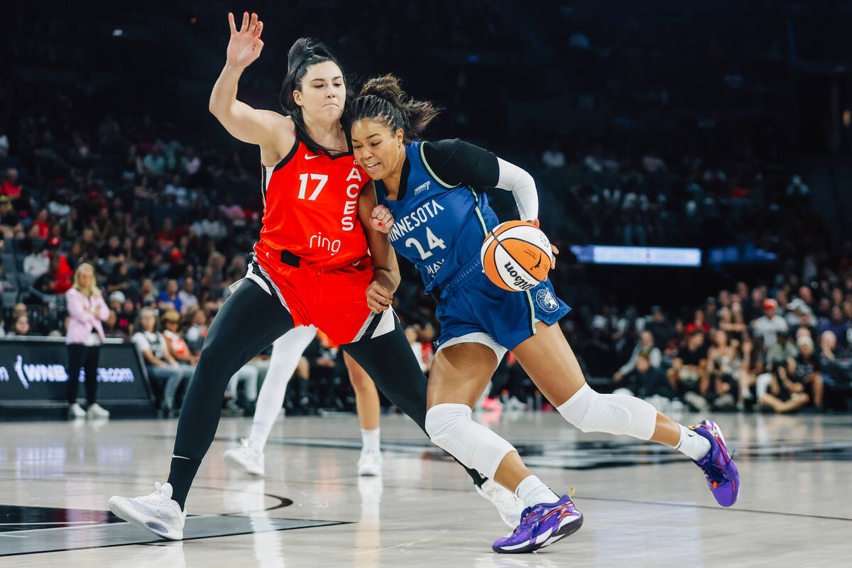 Minnesota Lynx forward Napheesa Collier (24) brushes up against Aces center Megan Gustafson (17 ...