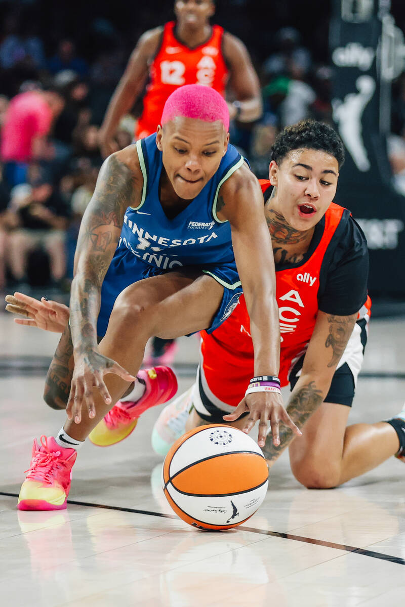 Aces forward Kierstan Bell (1) and Minnesota Lynx guard Courtney Williams (10) race for a loose ...