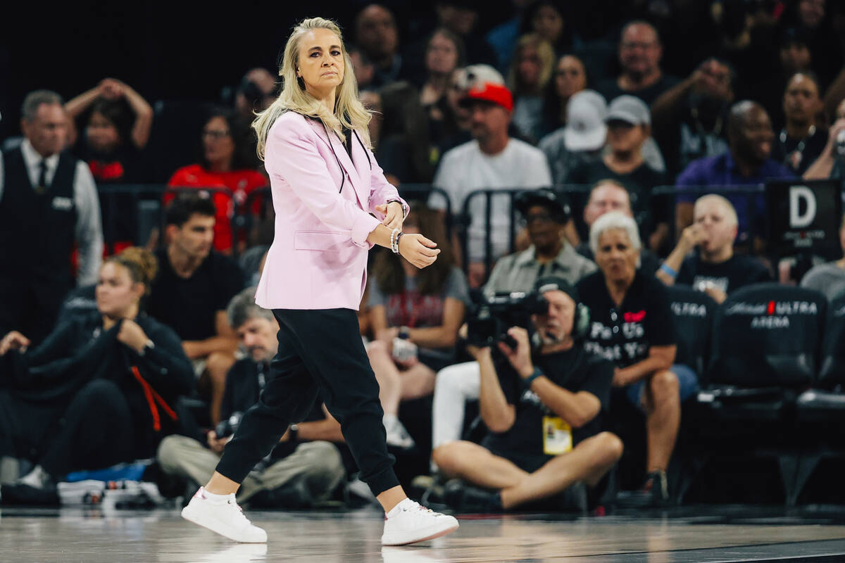 Aces head coach Becky Hammon walks on the court during a time out during a WNBA basketball game ...