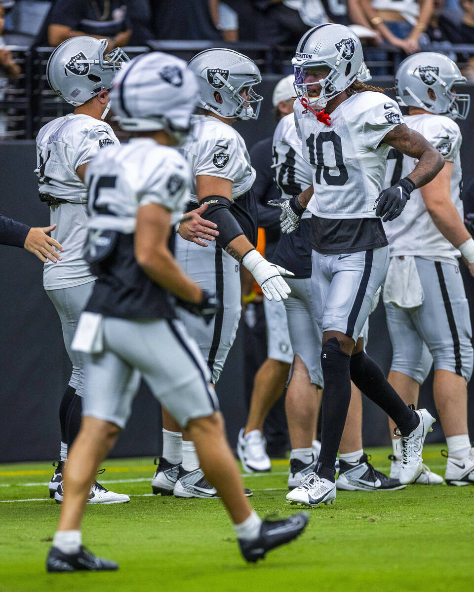 Raiders wide receiver Dont'e Thornton Jr. (10) greets teammates during the first half of a Raid ...