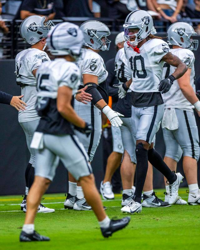 Raiders wide receiver Dont'e Thornton Jr. (10) greets teammates during the first half of a Raid ...