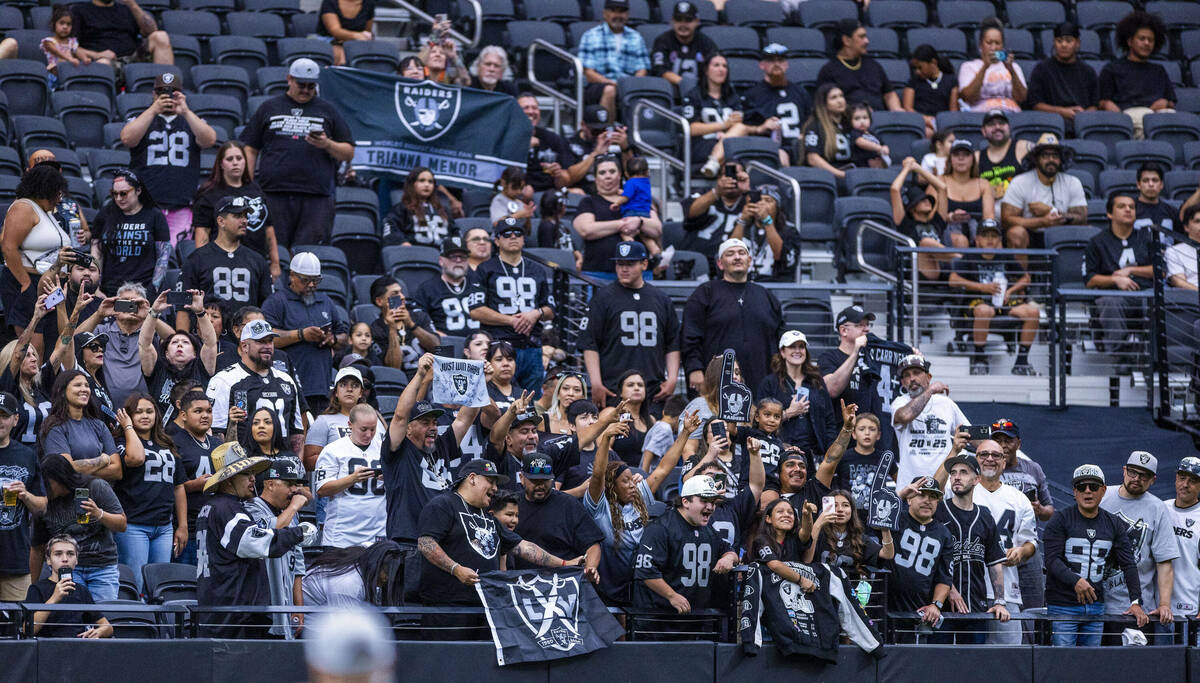 Raiders fans cheer for their team during the first half of a Raiders training camp mock game at ...