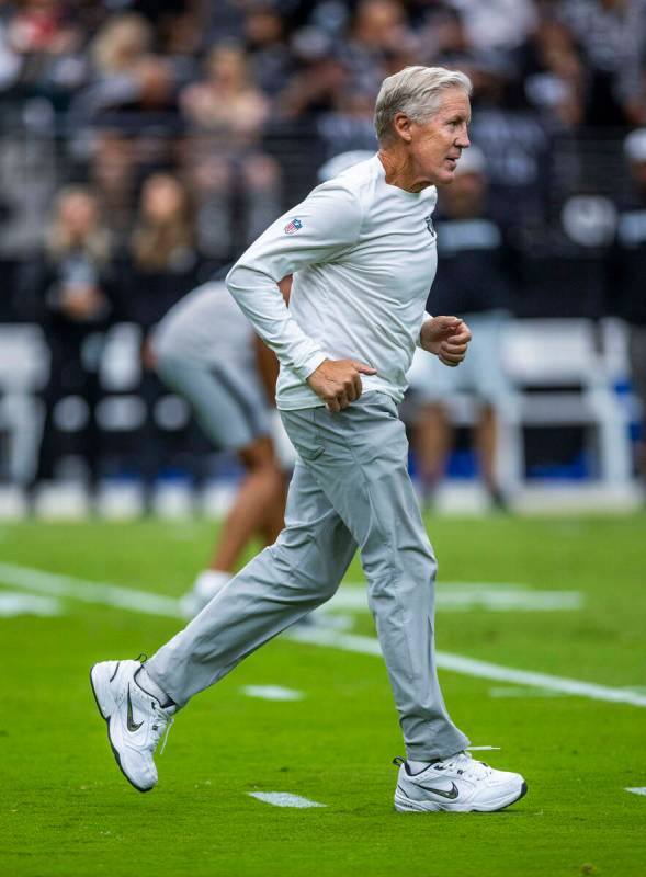 Raiders head coach Pete Carroll runs across the field during the first half of a Raiders traini ...