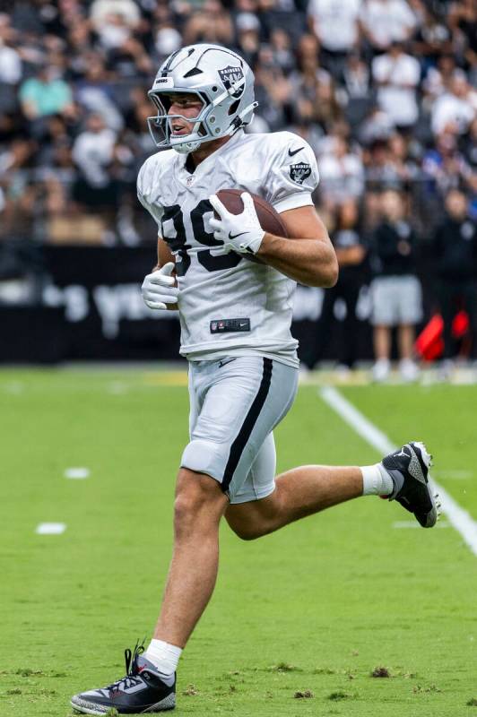 Raiders tight end Brock Bowers (89) runs after a catch during the first half of a Raiders train ...