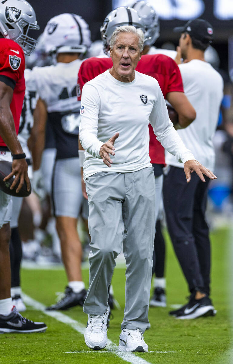 Raiders head coach Pete Carroll confers with an official during the first half of a Raiders tra ...